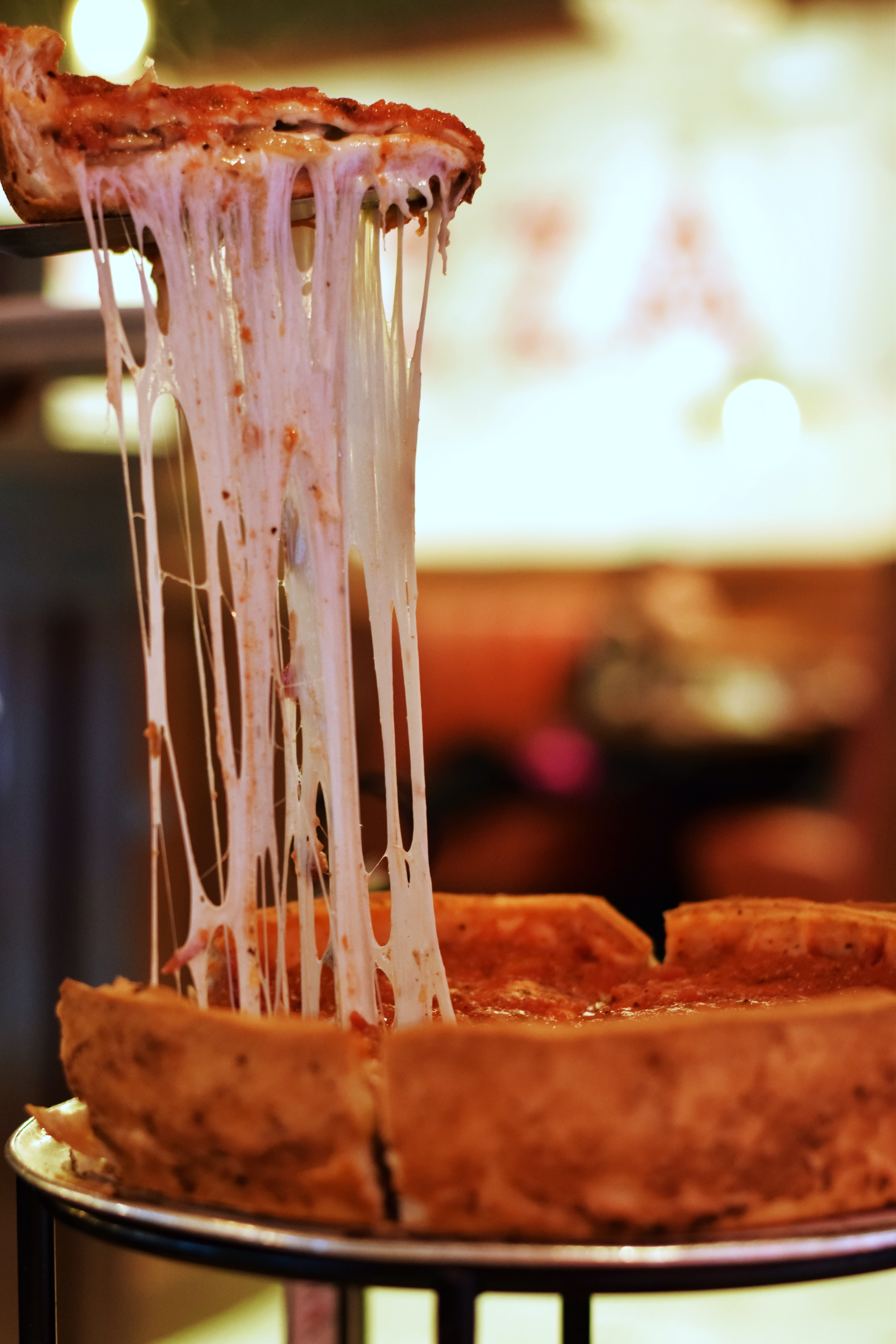 Stringy entangled cheese from a slice of deep dish pizza.