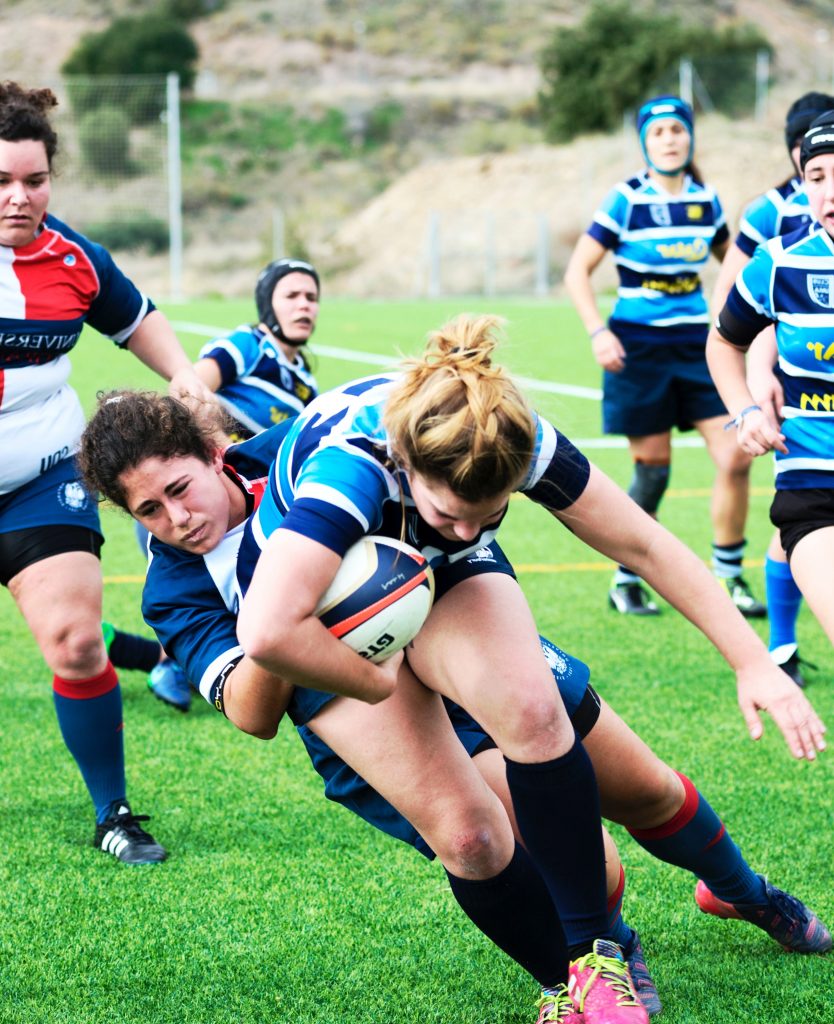 Tackle in a women's rugby match.